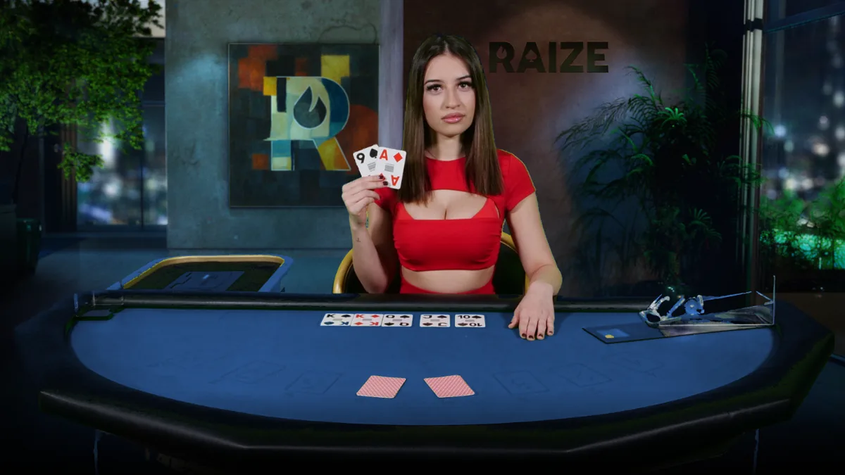 A RAIZE dealer at a blue-felt poker table in the studio, cards dealt on the board